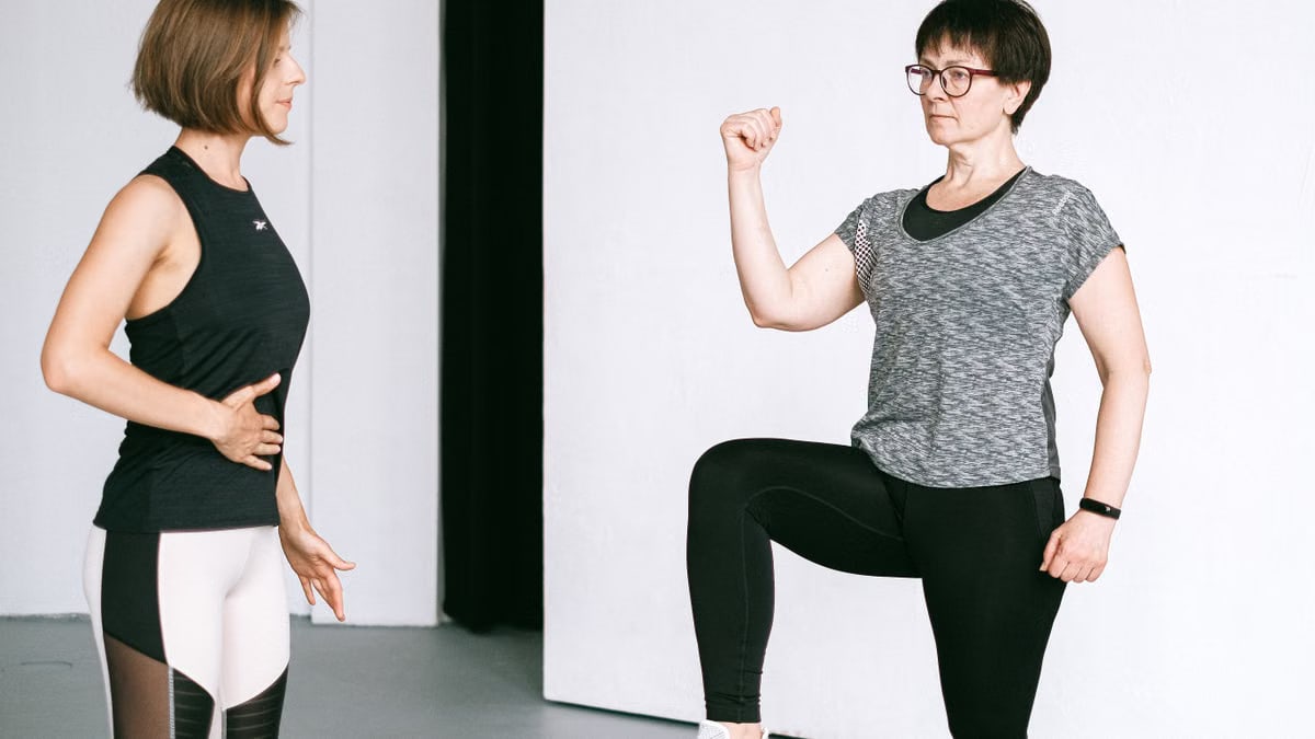 Two women working out together, demonstrating fitness exercises on a white background.